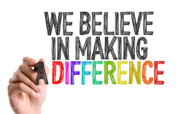 Hand with marker writing We Believe in Making a Difference-1